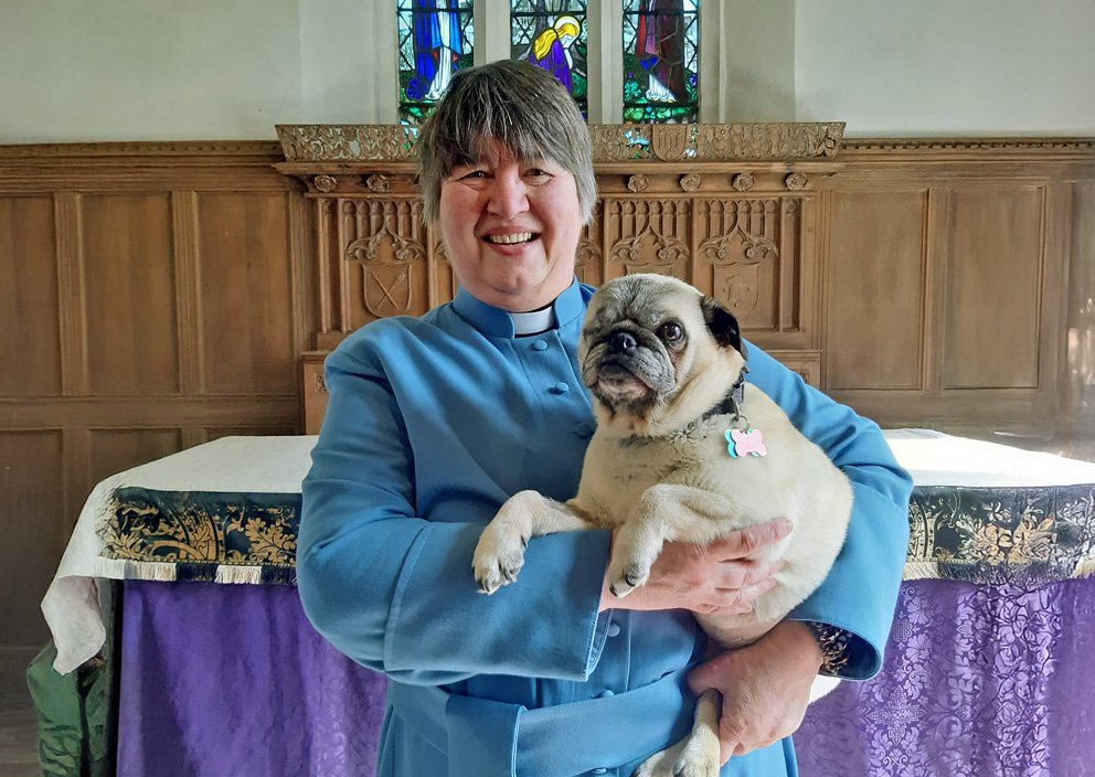 Julie the Vicar with one of her fostered pugs