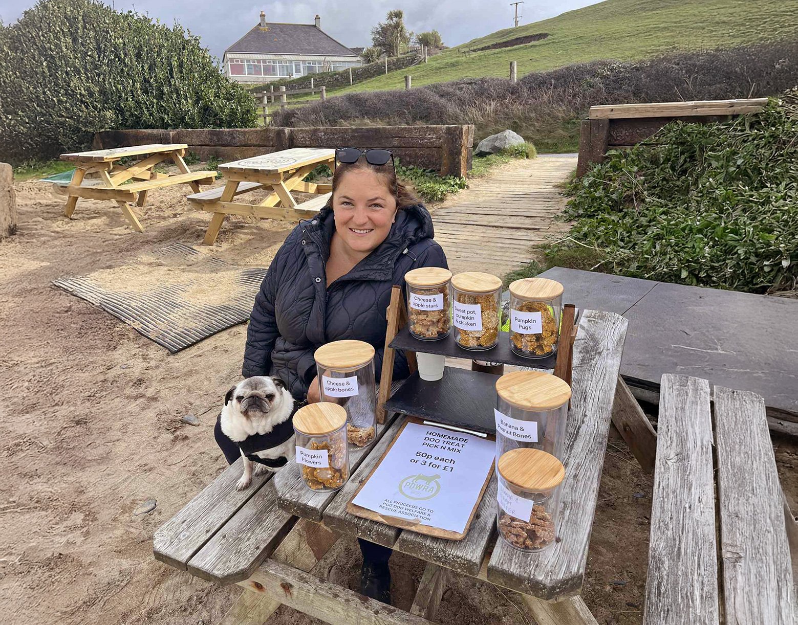 Fundraiser Natalie outside the Poldhu Beach Cafe